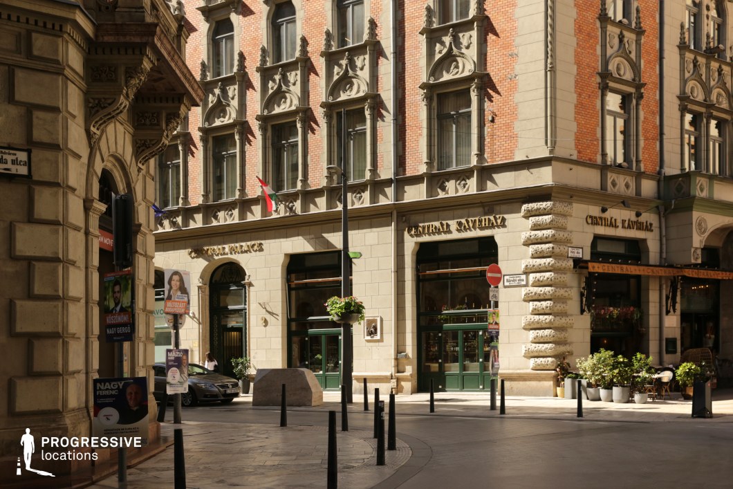 Historic cafe building with ornate brick facade, used for photo and film shoots in a detailed urban corner setting