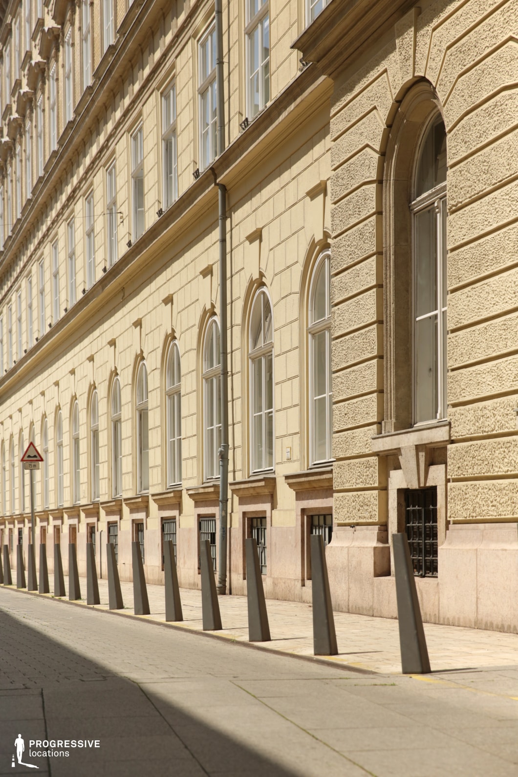 Long facade with repeating arched windows, a photography and film location defined by symmetry and linear perspective