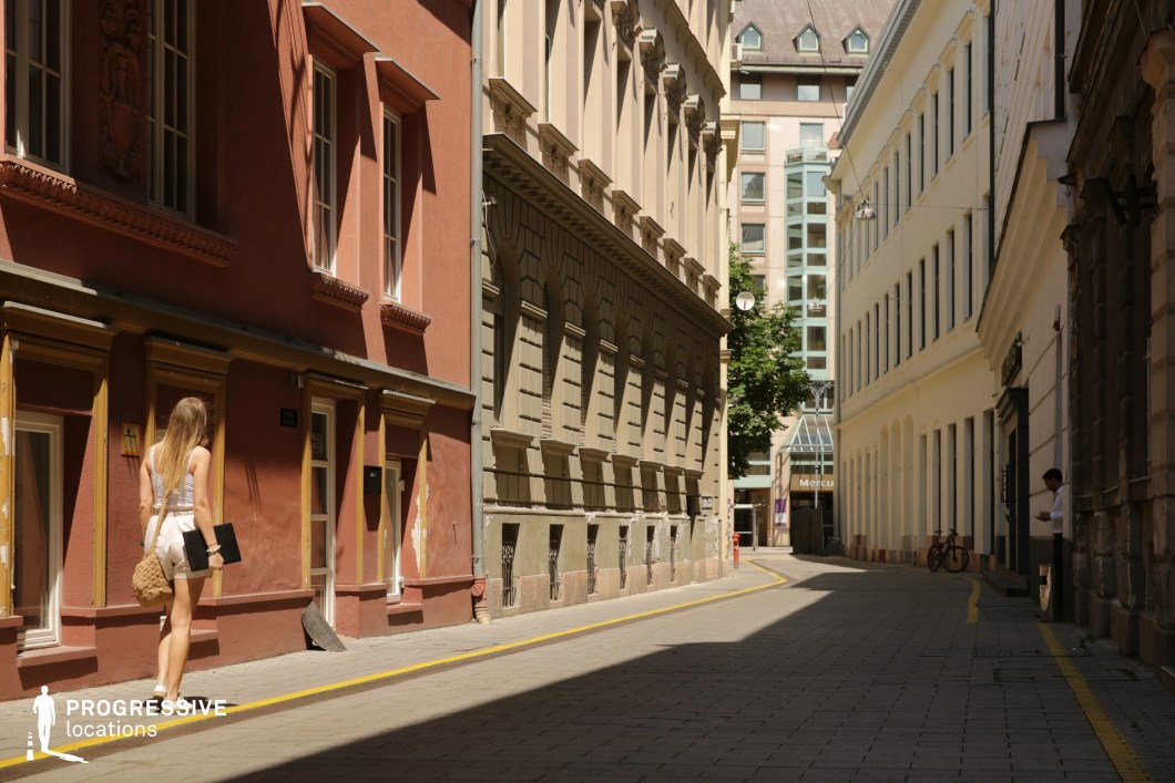 Narrow street with mixed facades and depth, photography and film location with layered urban perspective and varied textures