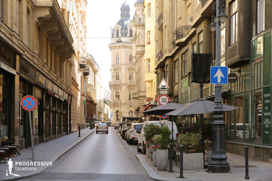 Narrow city street with mixed historic facades, used for photo and film shoots with strong linear perspective