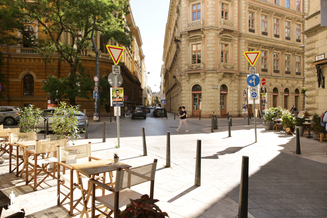 Open intersection with terrace seating and ornate buildings, film and photography location with flexible urban layout