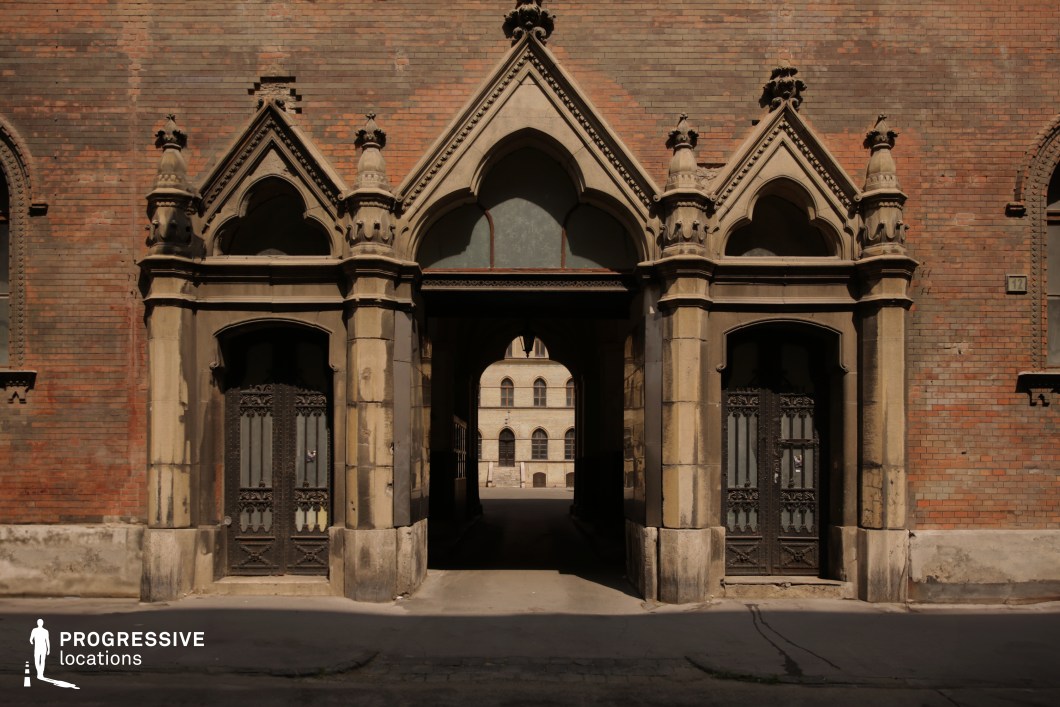 Symmetrical gothic arched entrance with central passage used as a photography and film location with strong depth alignment