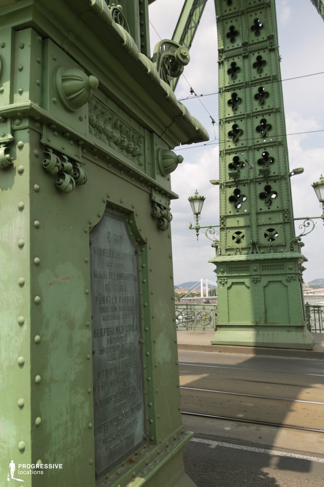 Detailed green steel bridge structure with rivets and tower elements as a photography and film location