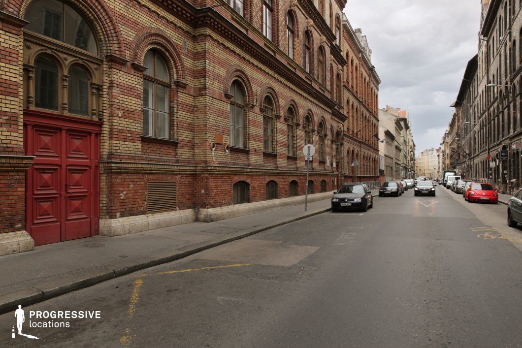 Narrow street lined with historic brick buildings forming a film and photography location with strong perspective