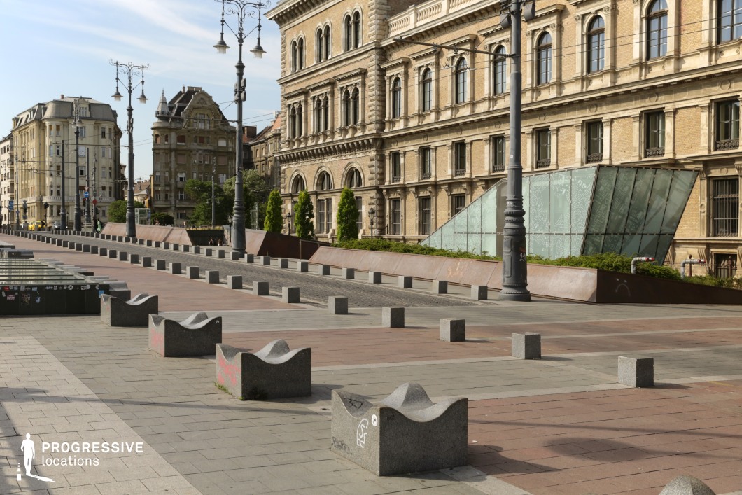 Open urban square with historic buildings and modern glass structure as a film and photography location