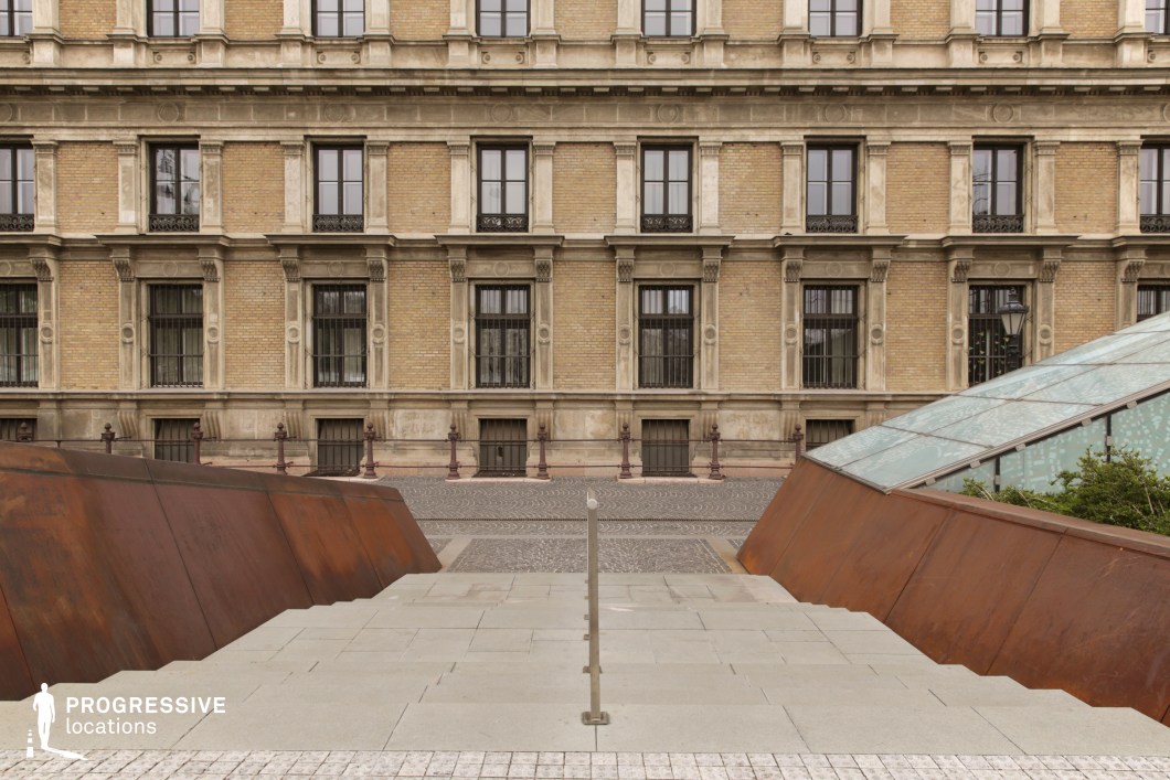 Symmetrical urban stairs with modern metal sides leading to historic facade as a film and photography location