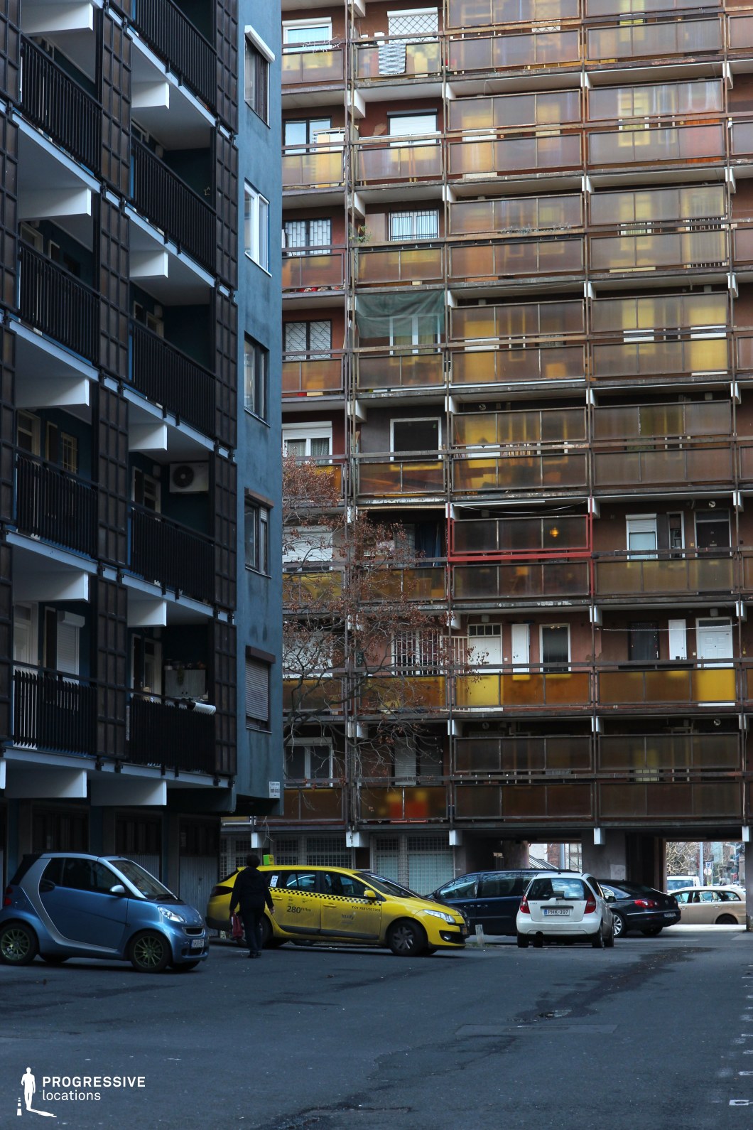 Dense apartment facade with repeating balcony grid, film and photography location emphasizing layered urban structure