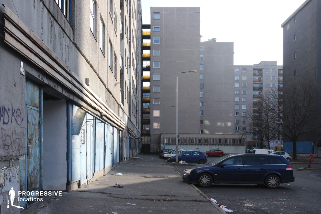 Narrow concrete alley with garage doors and residential blocks, a shooting location for film and photography projects