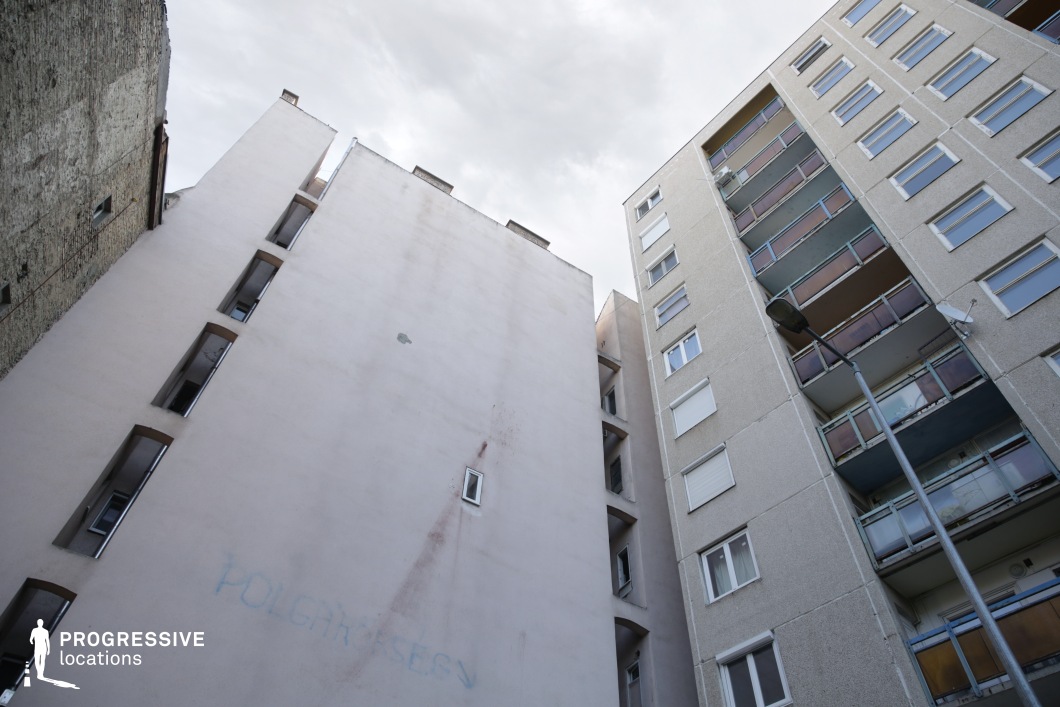 Low angle view of tall apartment buildings, film and photography location emphasizing vertical urban geometry