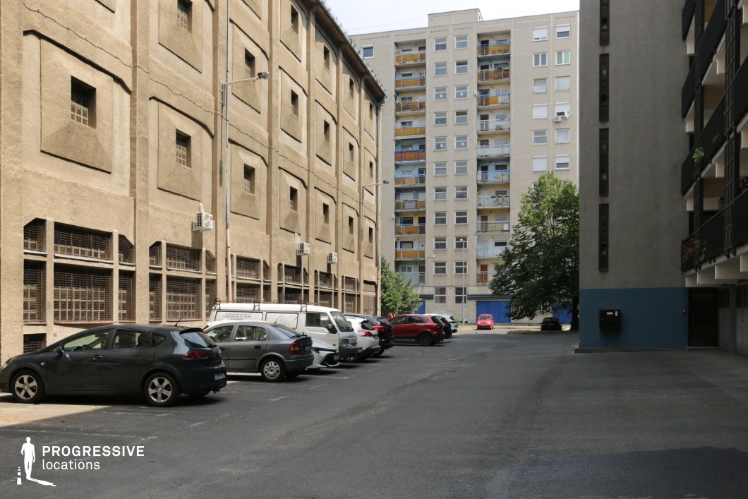 Long residential alley with contrasting building facades, shooting location for film and photography projects with strong depth