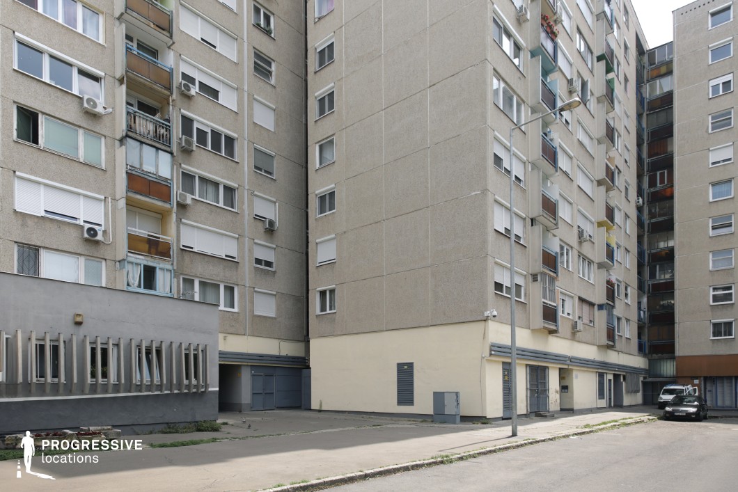 Residential street lined with apartment facades and balconies, ideal location for photography and filming with clear urban depth