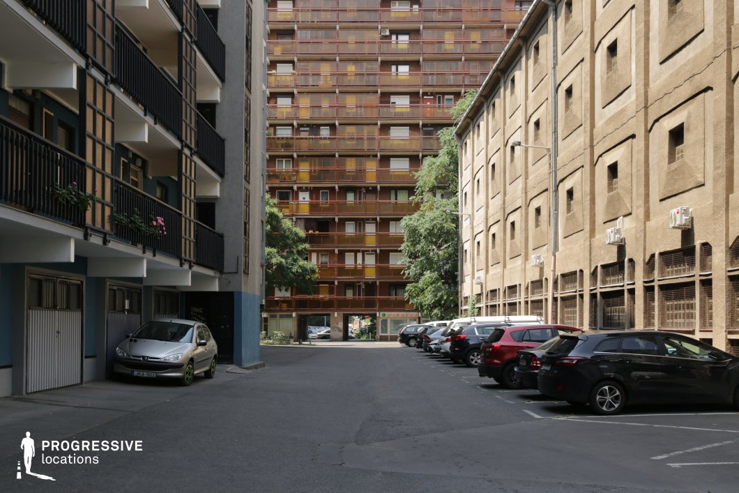 Enclosed urban courtyard with apartment blocks and balconies, ideal film and photography location with strong geometric depth