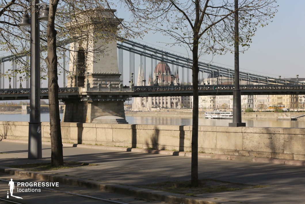 Bridge framed by trees and street elements as an ideal location for photography and filming with layered depth