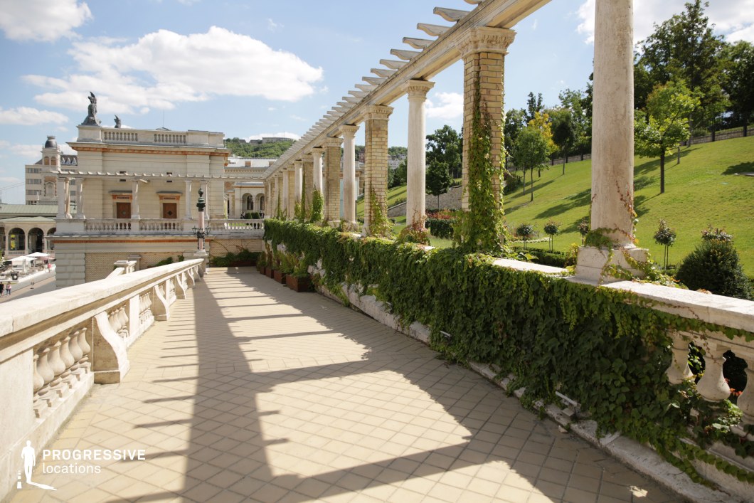 Column-lined terrace walkway ideal location for photography and filming with strong linear perspective and stone details