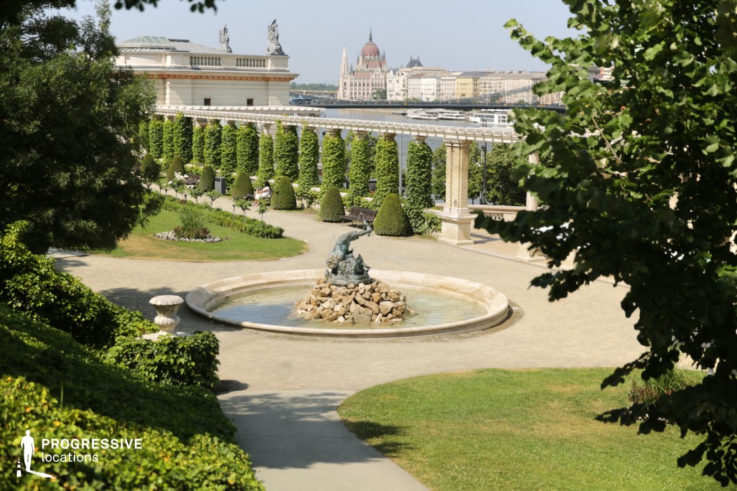 Formal garden with fountain and pergola walkway used for photo and film shoots in a structured landscape setting