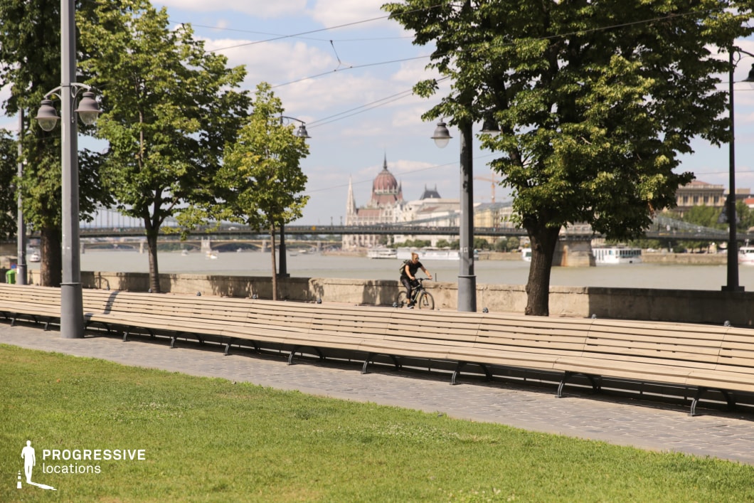 Long bench along promenade creates an ideal location for photography and filming with linear perspective and riverside setting