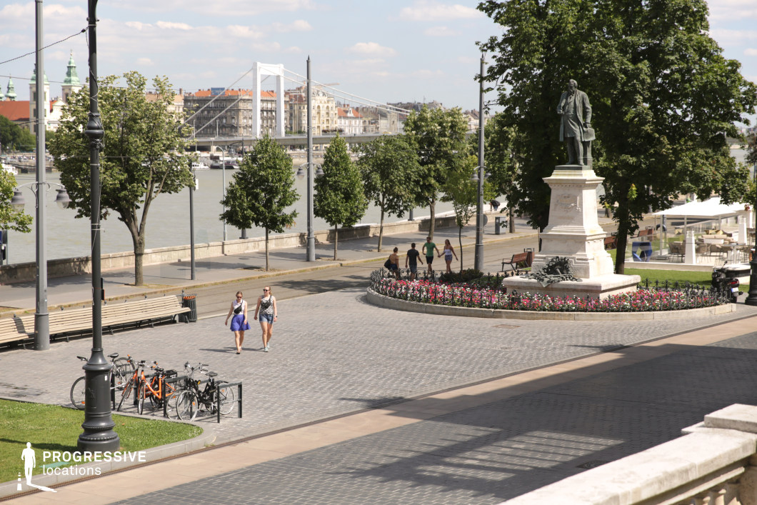Statue in riverside square as a photography and film location with open paved space and urban backdrop