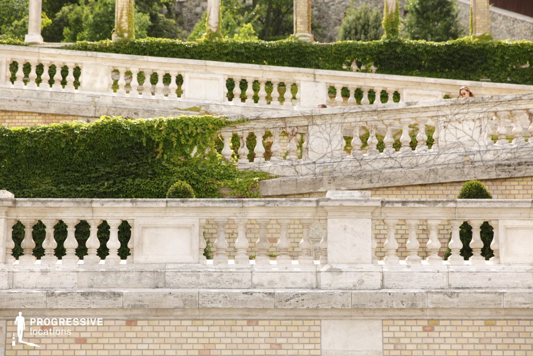 Layered stone terraces with balustrades form a photography and film location with geometric steps and greenery