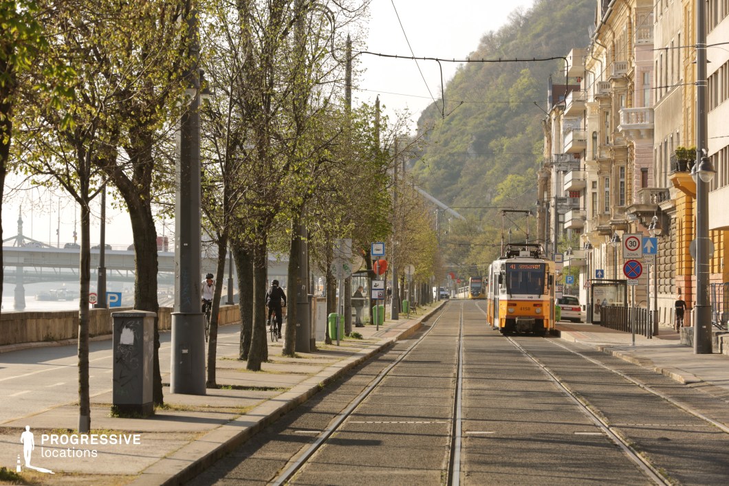 Urban street with tram tracks forms a film and photography location with strong perspective lines and historic facades
