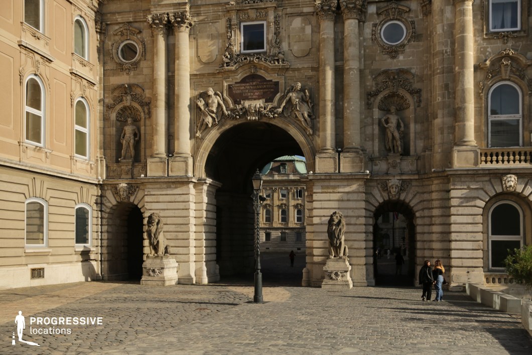 Grand sculpted arch gateway, photography and film location with detailed stone carvings and symmetrical composition