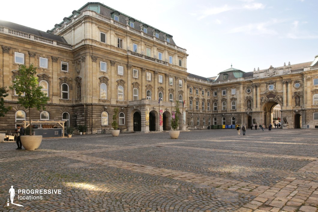 Wide palace courtyard with surrounding facades, photography and film location offering open space and structured architectural backdrop