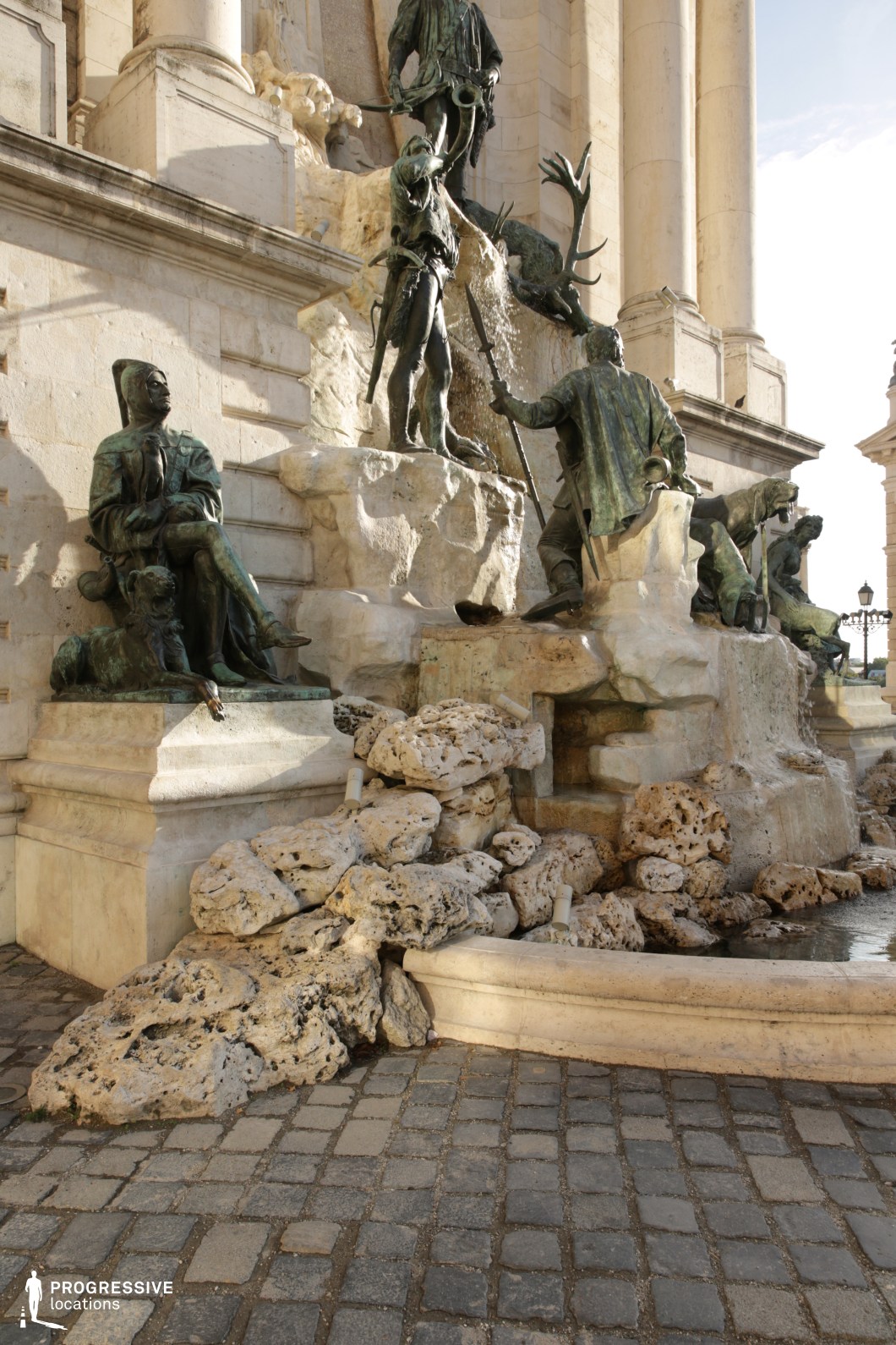 Sculptural fountain with bronze figures and stone base, ideal location for photography and filming highlighting texture and form