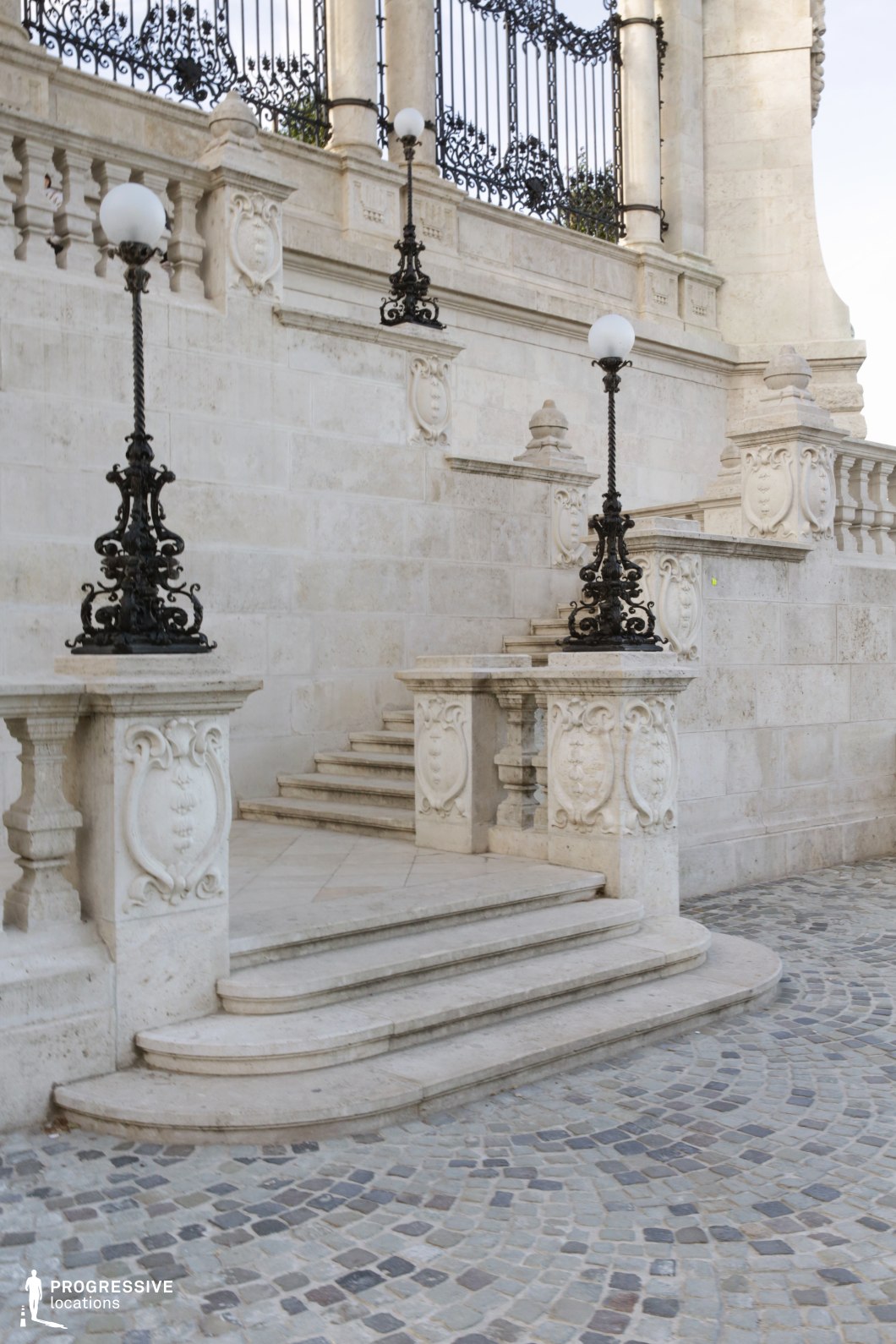 Decorative stone staircase with ornate lamps, film and photography location focused on detailed craftsmanship and textures