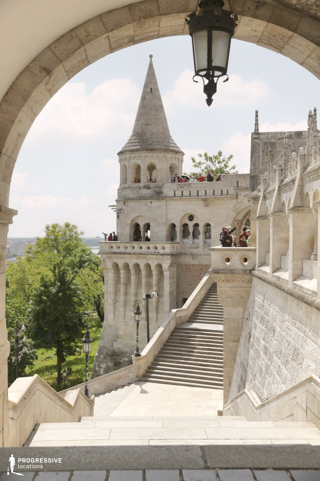 Stone stairs and tower framed by archway, shooting location for film and photography projects with layered architecture