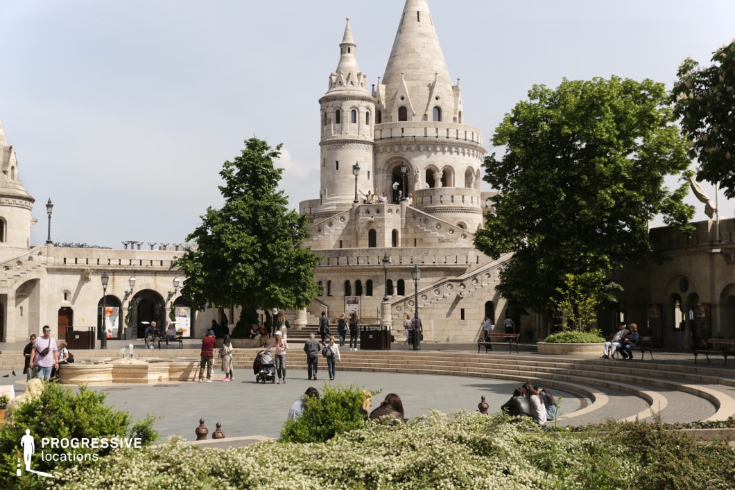 Open courtyard with central tower and arcades, suitable location for photography and filming with clear spatial layout