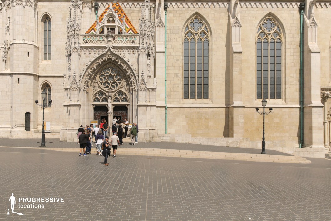 Gothic church entrance and facade, ideal location for photography and filming with large open square and vertical details