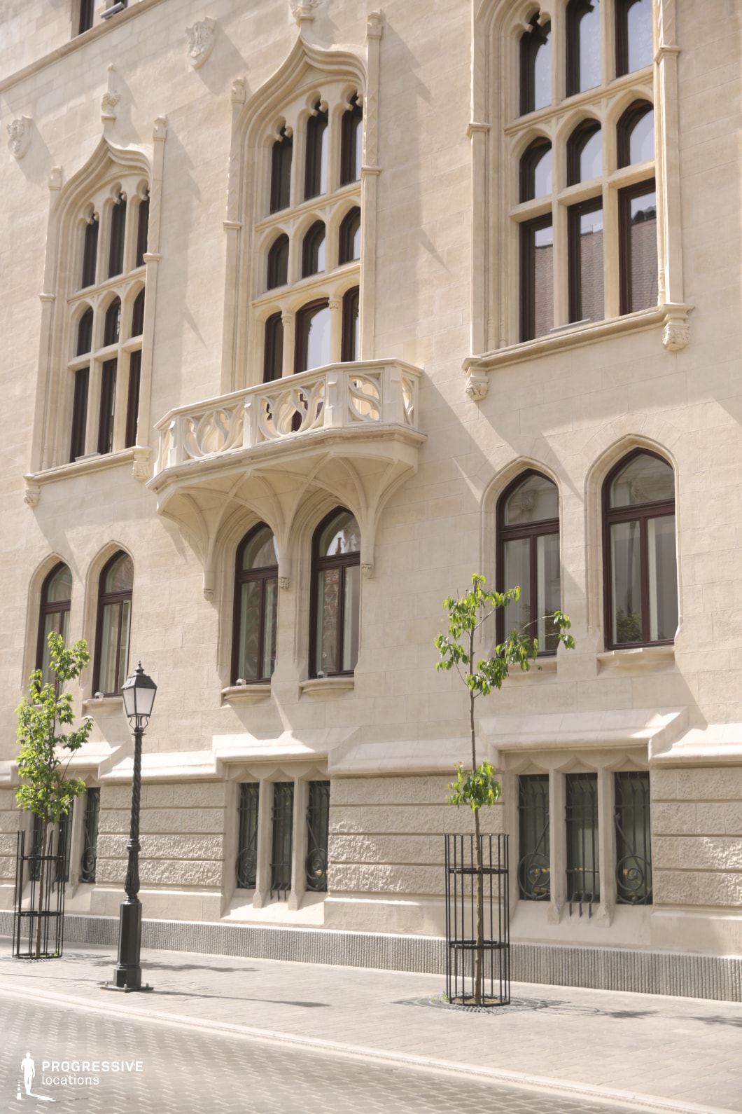 Historic facade with arched windows and balcony, an ideal film and photography location with refined architectural details