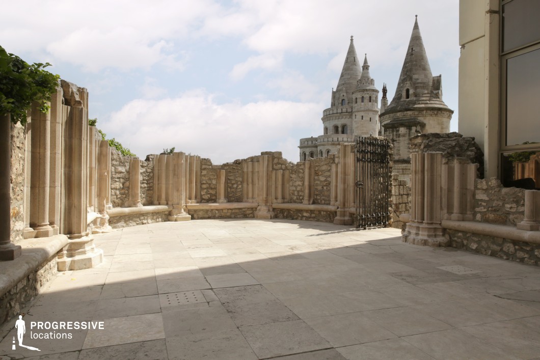 Stone ruins courtyard with columns, available for filming or photo shoots with textured walls and enclosed layout