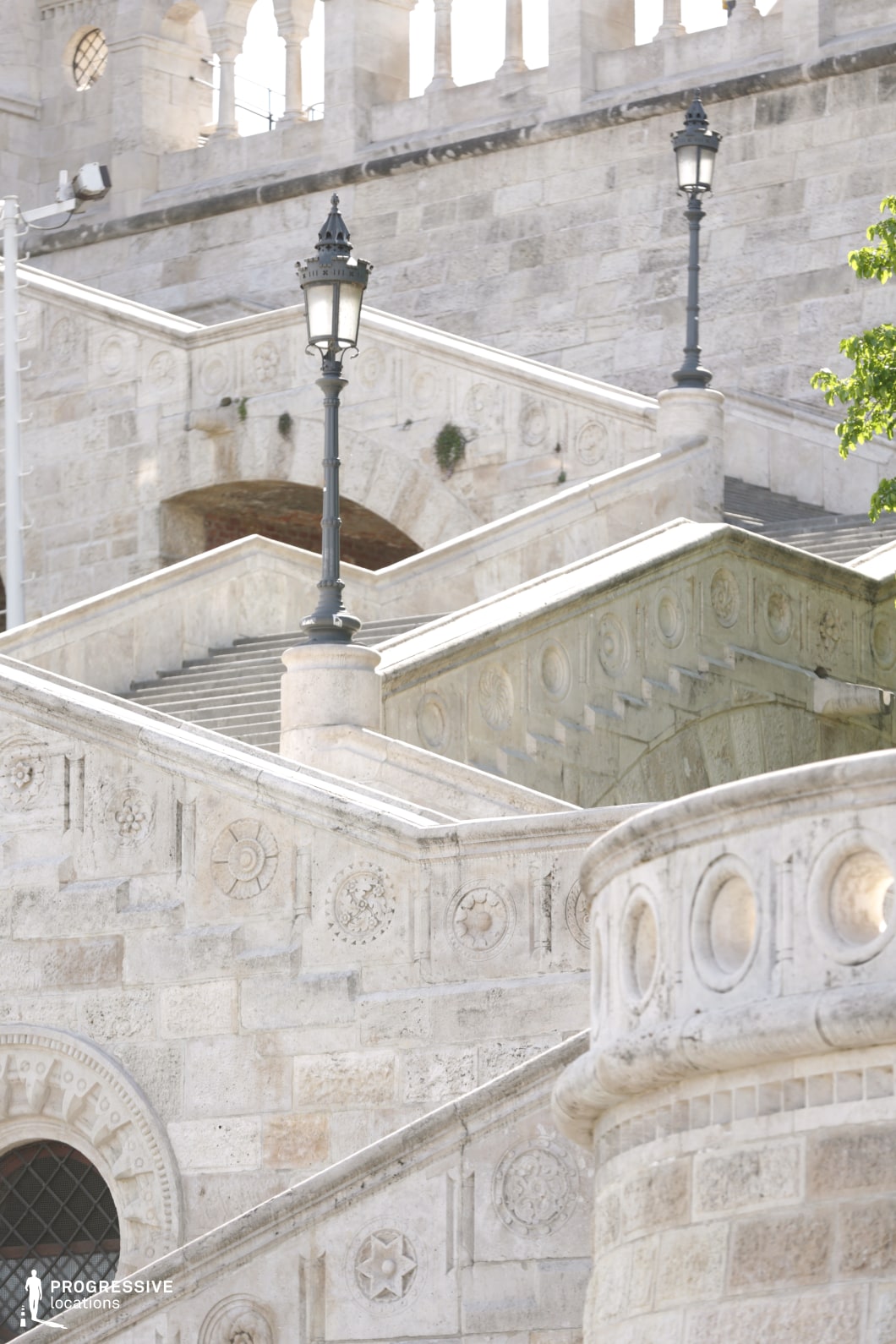 Layered stone stairs with ornate details and lamps, used for photo and film shoots focusing on architectural textures
