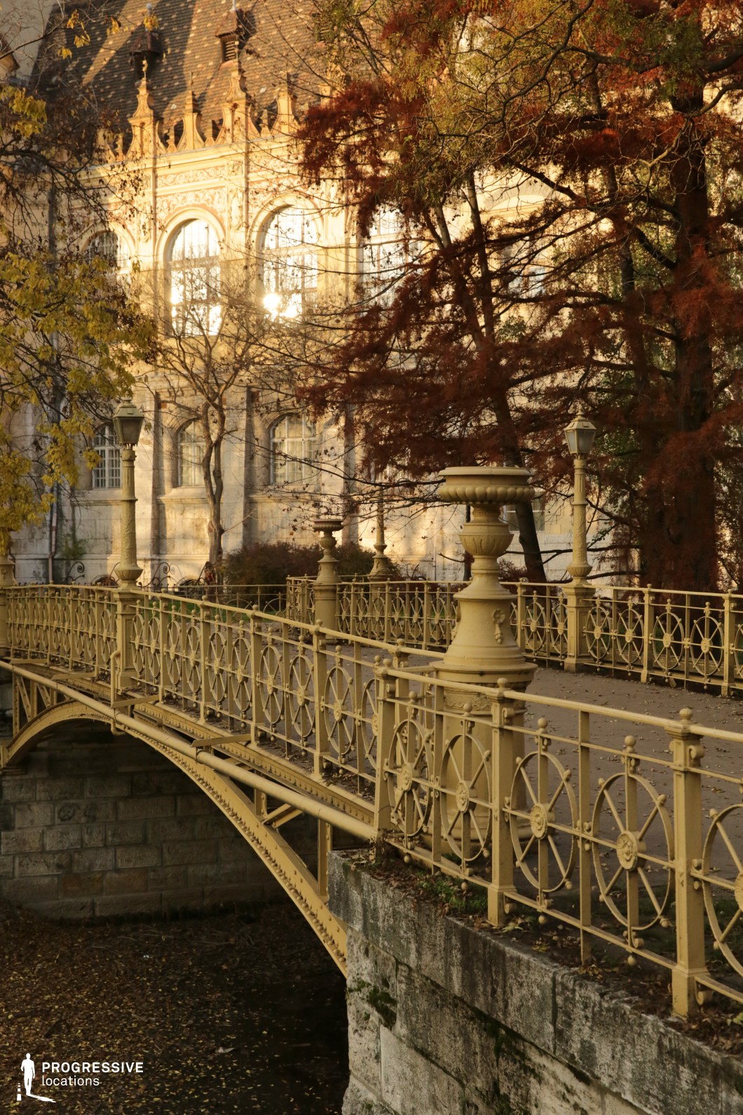 Ornate bridge leading to historic palace facade, available for filming or photo shoots with decorative railings and detailed architecture