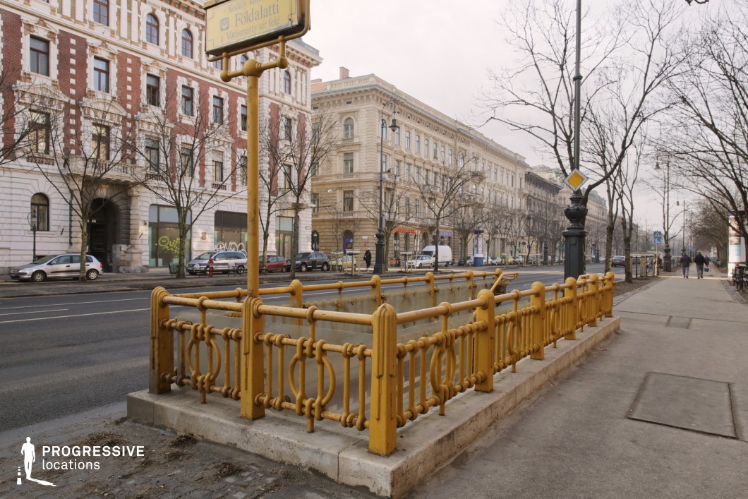Boulevard with metro entrance railings serves as a film and photography location with strong linear perspective