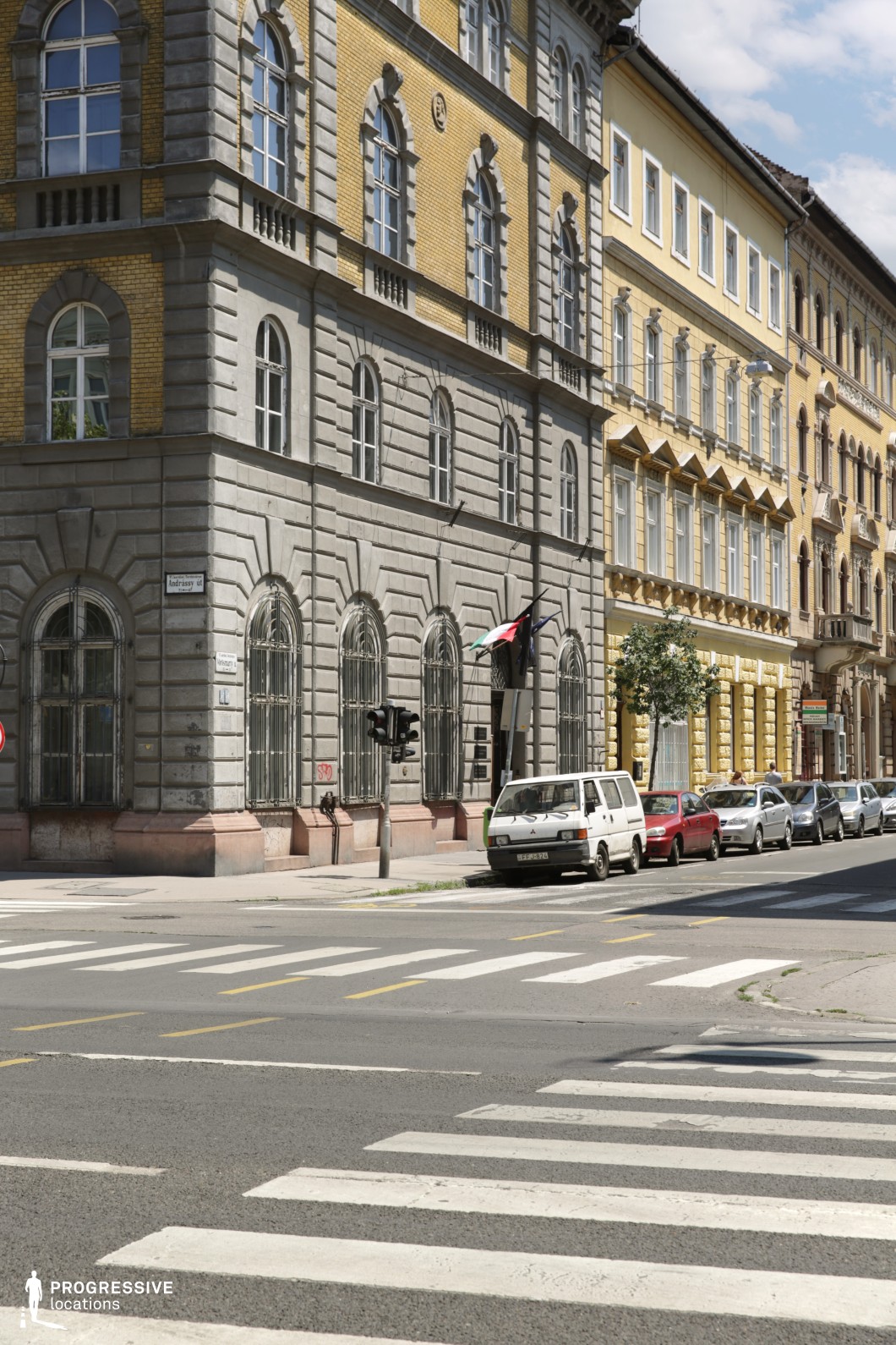 Historic street junction with crosswalk and detailed facades creates a film and photography location with strong geometry