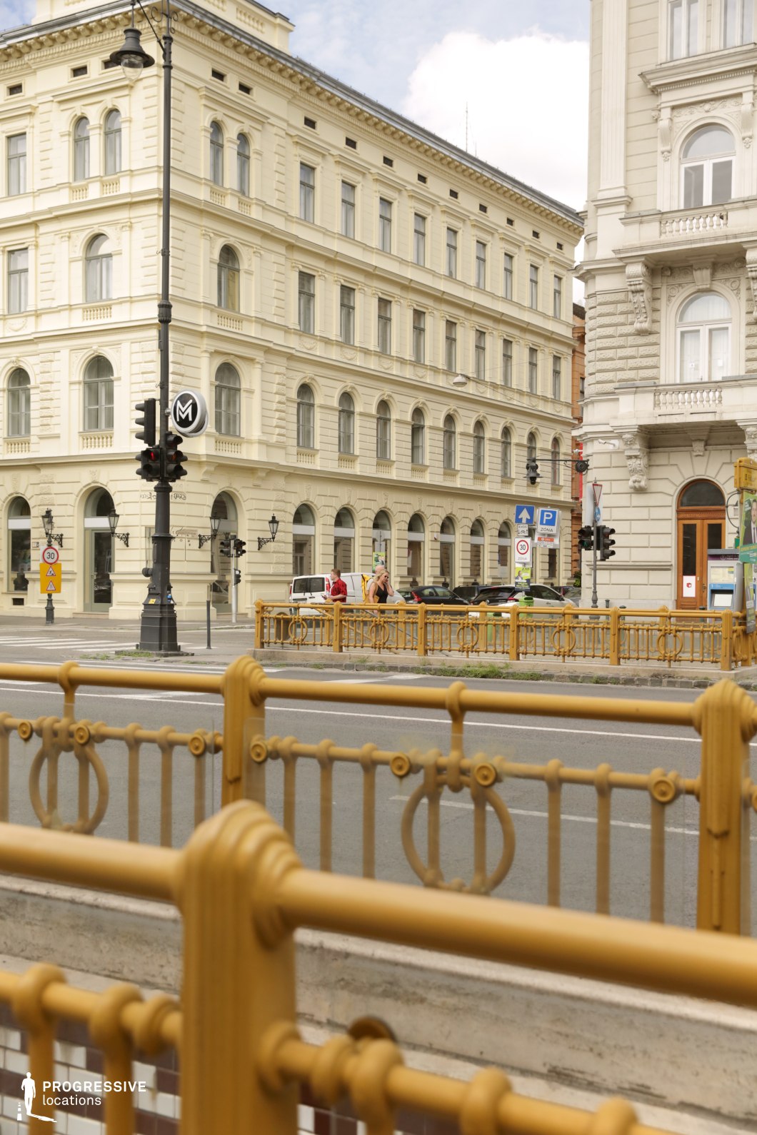 Decorative railings in foreground with historic boulevard buildings create a film and photography location with layered depth