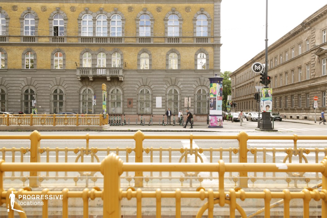 Foreground railings and historic facade form a photography and film location with layered urban composition