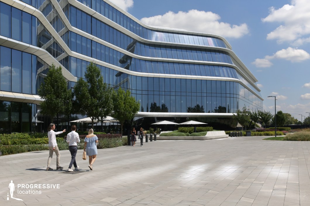 Curved glass office building and plaza used for photo and film shoots