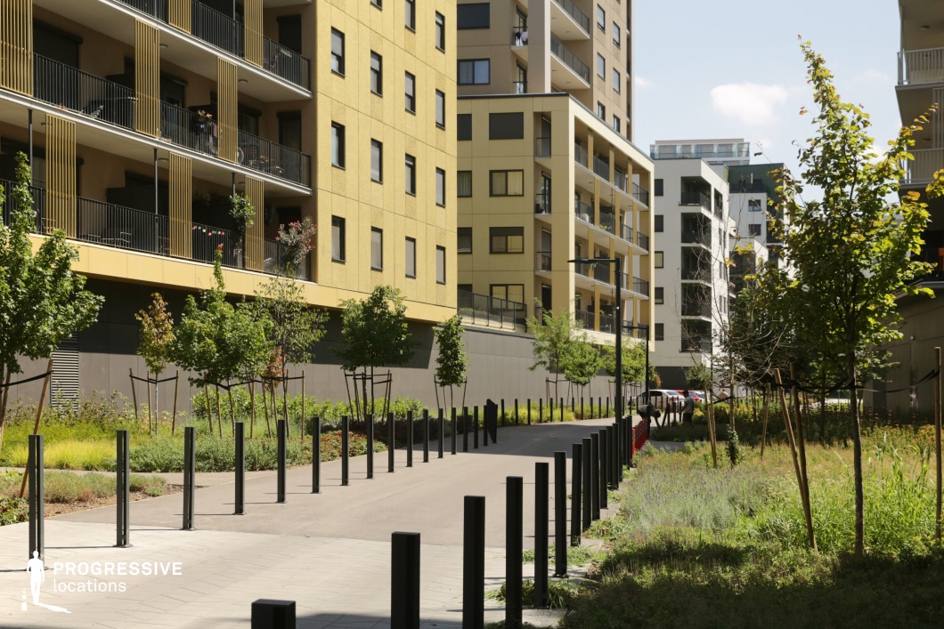 Residential pathway with bollards and modern buildings, ideal location for photography and filming