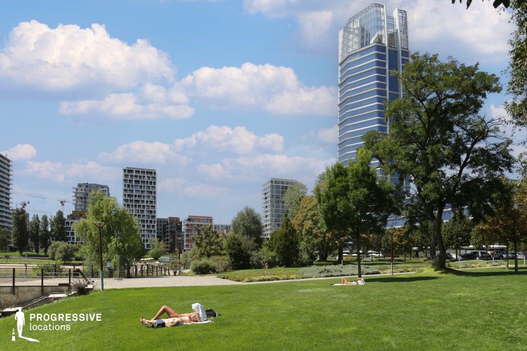 Urban park with skyline and tower, film and photography location with open green space