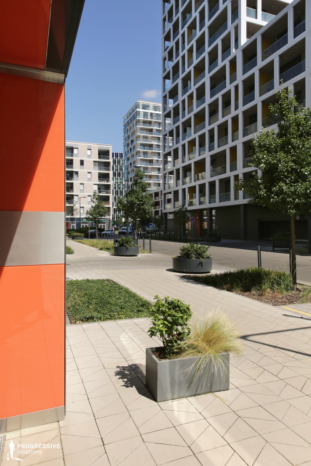Urban street with planters and modern buildings, film and photography location with structured layout