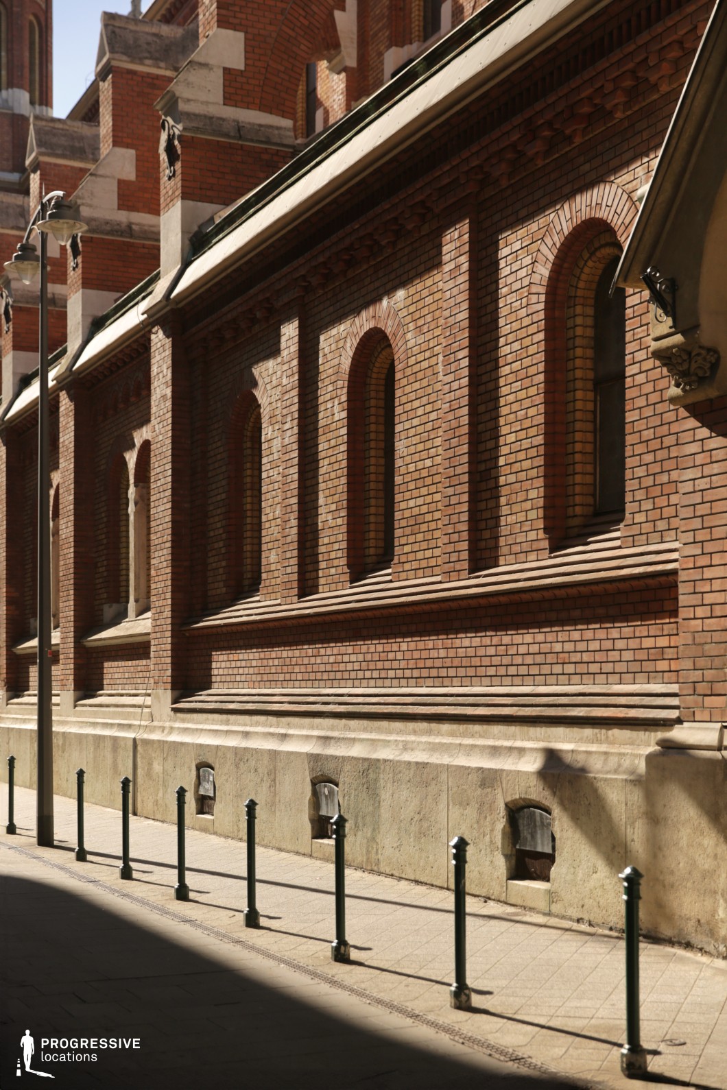 Brick building with repeating arched windows forms a photography and film location with strong linear composition and texture