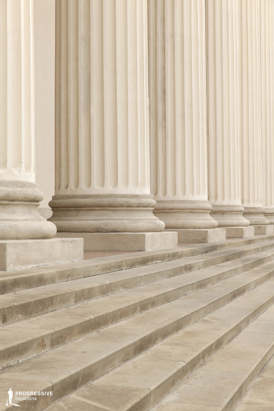 Close view of fluted columns and stone steps offers a clean film and photography location focused on texture and geometry