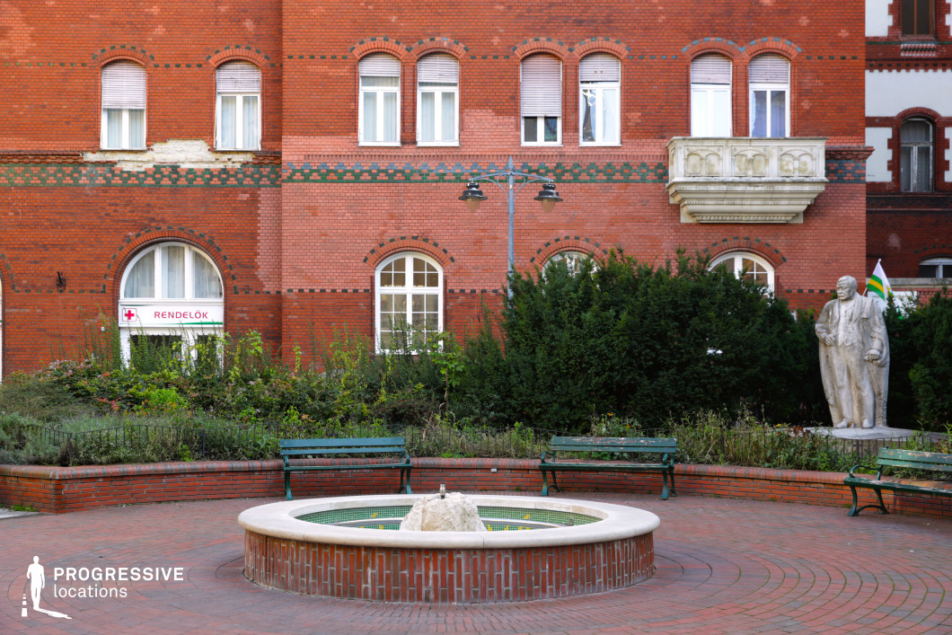 Circular fountain in red brick courtyard offers a balanced film and photography location with strong central focus