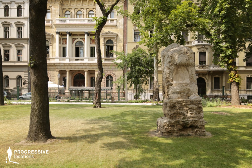 Historic buildings and stone monument in green park create a detailed film and photography location with layered depth