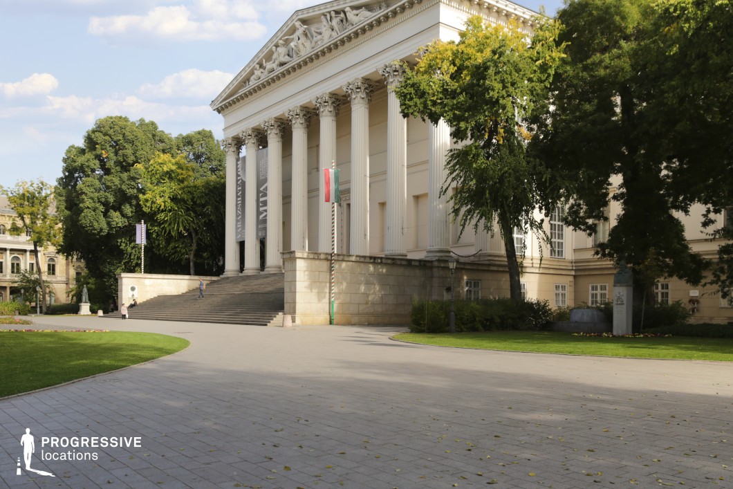 Grand columned neoclassical facade and wide steps form an ideal film and photography location with open plaza foreground
