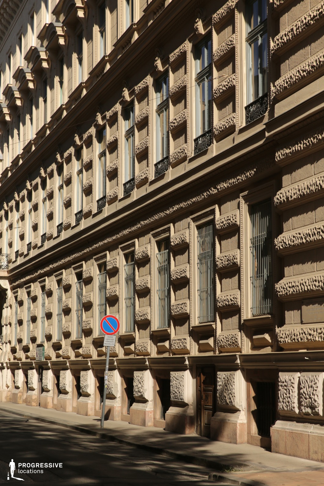 Repetitive ornate windows and textured facade create a film and photography location emphasizing pattern and architectural rhythm