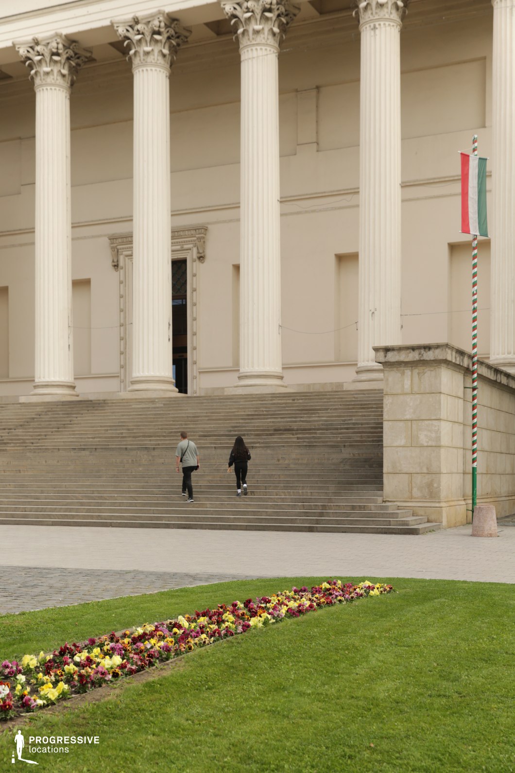 Wide stone steps and tall columns create a structured photography and film location with strong vertical architectural rhythm