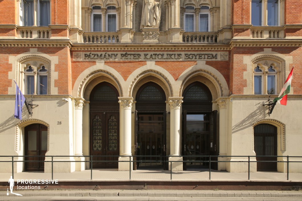 Arched university entrance with columns and detailed facade serves as an ideal film and photography location with formal symmetry